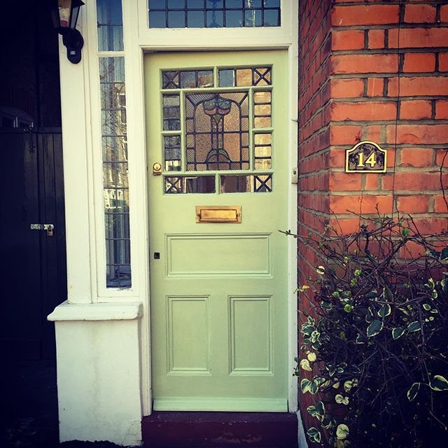 Front door repainted in pale green